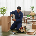 Professional carpenter doing doorstep furniture repair and assembly at home